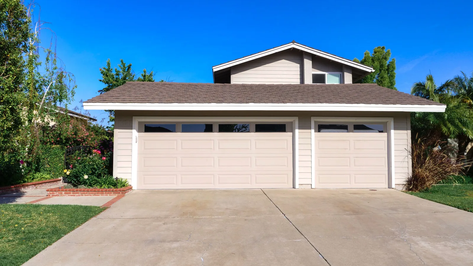 Exterior of a suburban house with an attached garage and driveway.