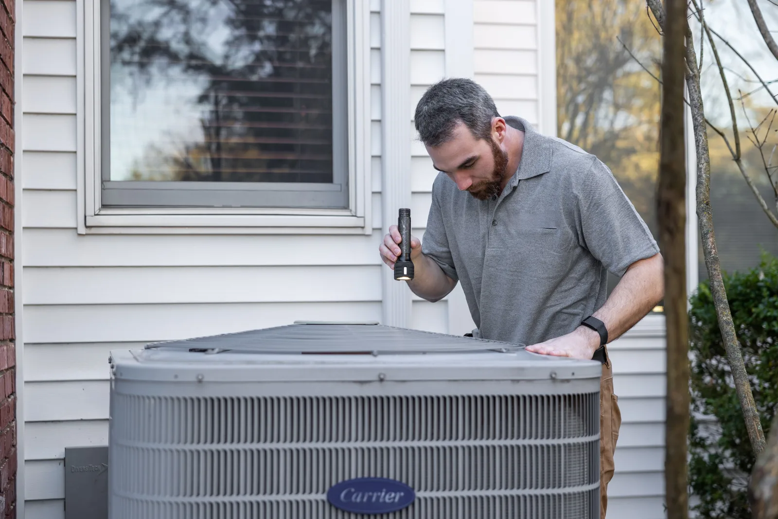 Rental property owner inspecting maintenance needs at a residential property.